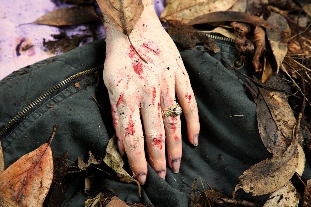 A dead zombie hand lying in the bushes for the Newly Weds film by Adelaide mobile hair and makeup artist Make-Overs Australia